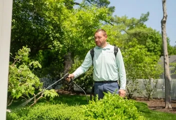 lawn-care-technician-with-sprayer