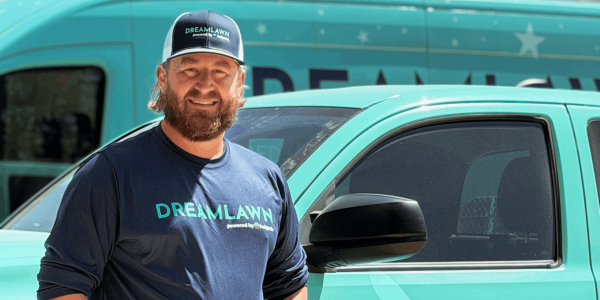 Aaron in front of a DreamLawn truck